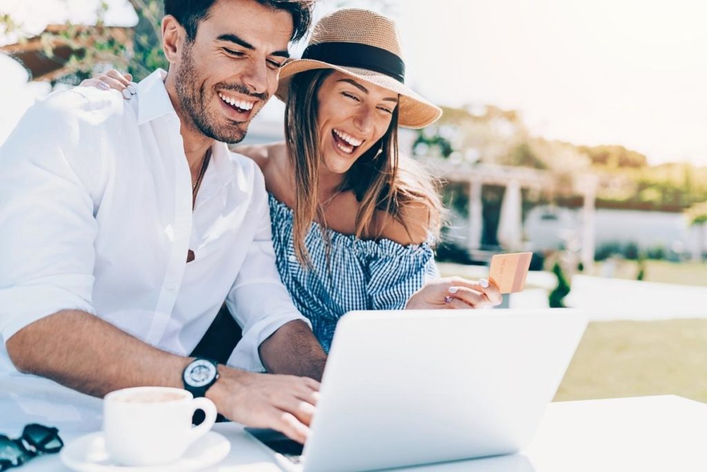 Smiling couple looking at laptop