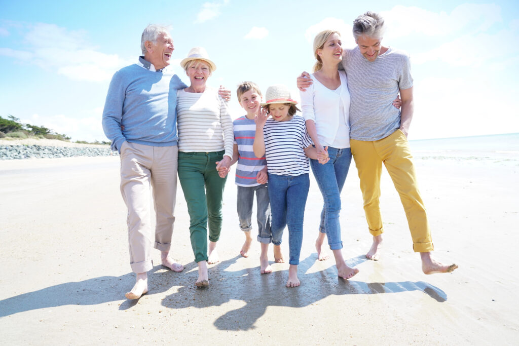 Intergenerational family walking on the beach