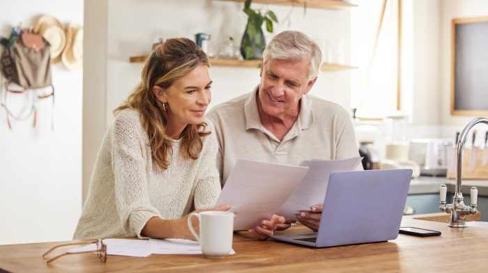 Retirement, finance and couple with budget on laptop satisfied with home expenses in New Zealand. H.